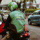 Unsplash/Afif Kusuma Un motociclista de una empresa indonesia de transporte espera a un pasajero.